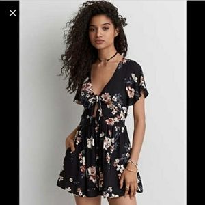 Black romper with small cut out in stomach